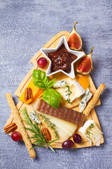 Christmas cheese platter. Cheese selection and appetizers for Christmas or New Year party dinner. View from above, top studio shot