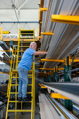 Control of materials for the production of PVC and aluminum profiles. A senior craftsman selects the material for the production of windows and doors.