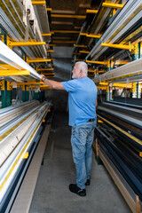 Control of materials for the production of PVC and aluminum profiles. A senior craftsman selects the material for the production of windows and doors.