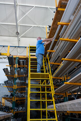 Control of materials for the production of PVC and aluminum profiles. A senior craftsman selects the material for the production of windows and doors.