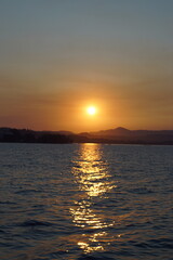 Fototapeta premium A stunning orange and pink sunset over the Greek Ionian Ocean in the Mediterranean Sea