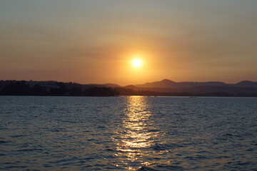 A stunning orange and pink sunset over the Greek Ionian Ocean in the Mediterranean Sea