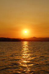 A stunning orange and pink sunset over the Greek Ionian Ocean in the Mediterranean Sea