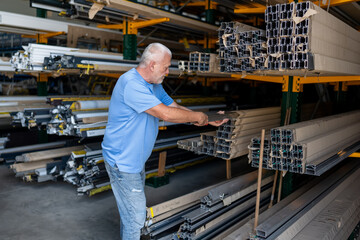 Control of materials for the production of PVC and aluminum profiles. A senior craftsman selects the material for the production of windows and doors.