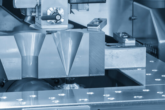 The die insert cutting process by wire EDM machine control by CNC program in the blue scene.