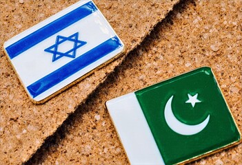 Israeli and Pakistani Flag Enamel Pins on Cork Board Diagonal Composition Travel Souvenir Background