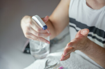 Obraz premium Man Manicure, Hand Disinfection with Alcohol