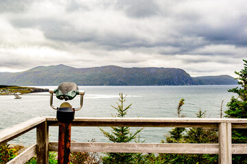 Lookout spot with binocular device view over Bonne Bay and Rocky Harbour on the west coast of...