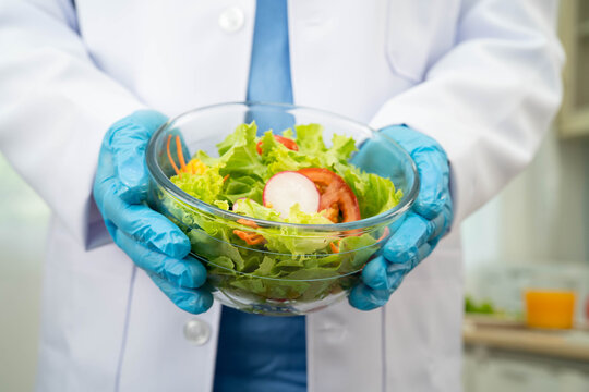 Asian Nutritionist holding healthy food for patient in hospital, nutrition and vitamin.