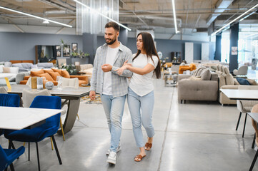Obraz premium Young couple choosing furniture in home decor showroom