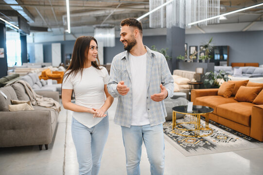 Couple shopping for furniture in showroom - Powered by Adobe