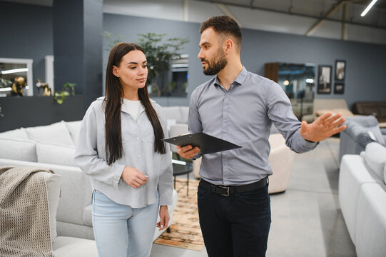 Sales consultant assisting client buying furniture in store