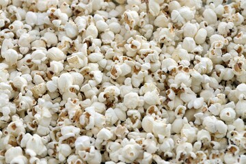 Flatlay of salted popcorn with cheese. Heap of homemade delicious popcorn on a rustic table