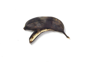 Blackened banana peel isolated on white background.