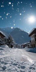 Fototapeta premium Snowy mountain village under clear blue sky and bright sun