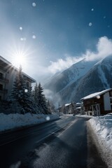 Scenic winter mountain landscape with snowy road and sunlit alpine trees