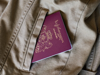 Passport placed inside a jacket pocket ready for travel