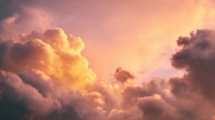 Fototapeta premium Dramatic sunset sky with fluffy cumulus clouds illuminated by warm golden and pink light creating a beautiful atmospheric background