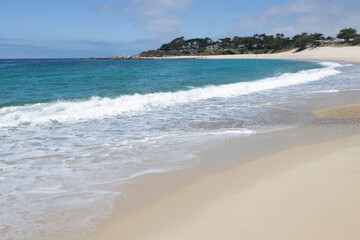 Carmel River State Beach in California USA with white sand, turquoise water, and calm lagoon at the river mouth, a scenic coastal destination for relaxation and photography
