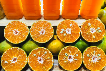 Halves of oranges on shelf showcase their freshness and pristine quality, straight from orchard,...