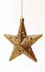 Gold star ornament hangs against a white background, used for holiday decoration