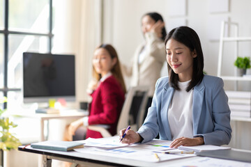 Businesswoman working in the office, she is reading and analyzing business reports in a meeting.