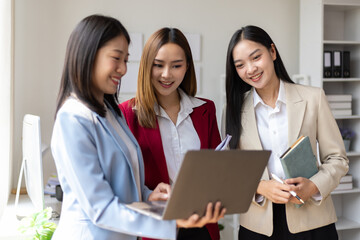 Business meeting, coworkers are discussing in the office. Happy business people discussing during meeting in board room at corporate office. Businesswoman interacting with a colleague.