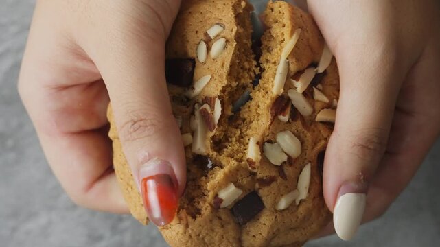 Close-Up of Hand Breaking Cookie, Sweet and Delicious Dessert.