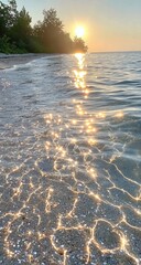 Sunlit ripples on shore; golden hour tints the sea