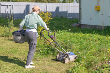 woman mowing grass