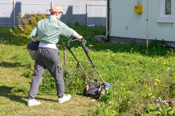 woman mowing grass
