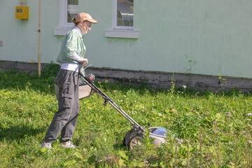 Woman mowing lawn