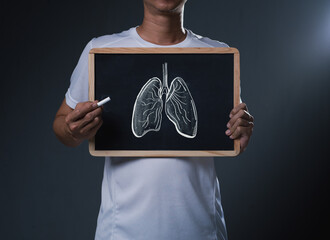 Man Holding Chalkboard with Hand-Drawn Lungs: Respiratory Health Education