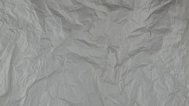 Stop motion animation paper texture background. 4k quality crumpled dark grey paper. Close-up wrinkled paper texture