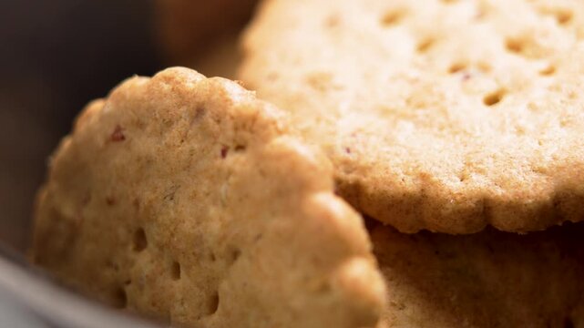Shortbread cookies with berry pieces are placed in a bowl. Sweet pastries. Macro shot