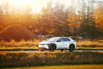 Fototapeta premium Elegant SUV on open road in sunlight