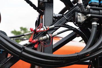 Obraz premium High pressure hydraulic hose system connected to steel pipes, close-up. Marine hydraulics.