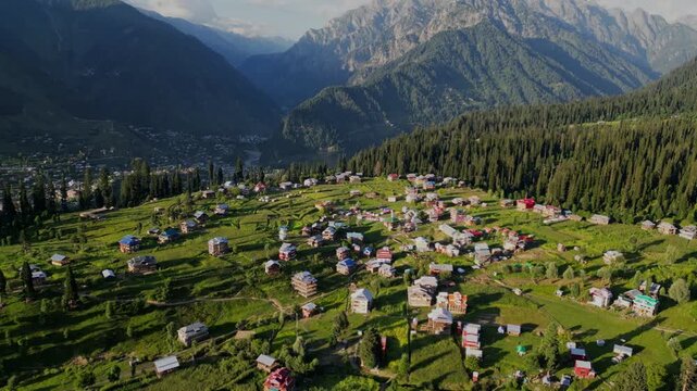 Aerial View of Arang Kel, Azad Kashmir &mdash; Scenic Mountain Village Surrounded by Lush Green Terraces, Dense Pine Forests, and Majestic Peaks under Clear Evening Light