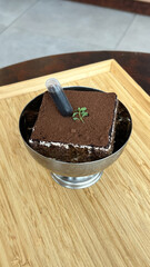 tiramisu cake original, italian dessert on wooden background.
