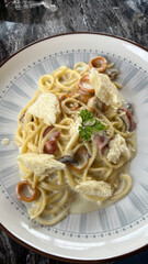 Classic carbonara pasta with pancetta, egg, hard parmesan cheese and cream sauce. Italian cuisine. Spaghetti alla carbonara.