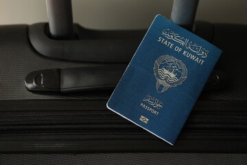 Kuwaiti passport on travel luggage. The concept of travel and vacation