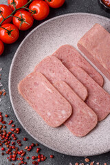 Spiced ham slices, canned meat for lunch sandwiches. Spiced ham as a food background