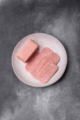 Spiced ham slices, canned meat for lunch sandwiches. Spiced ham as a food background