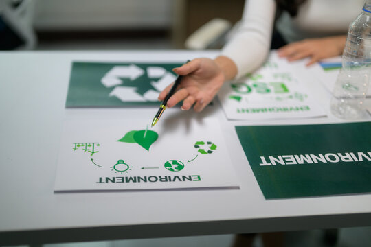 Person pointing to environmental sustainability circular economy diagram