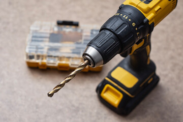 Cordless drill driver with a complete set of drill bits and screwdriver bits in a sturdy case. Versatile power tool for drilling and fastening.