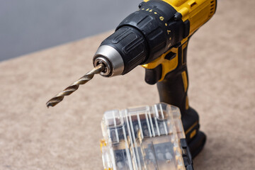 Cordless drill driver with a complete set of drill bits and screwdriver bits in a sturdy case. Versatile power tool for drilling and fastening.
