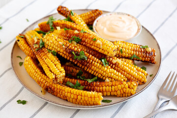 Homemade Spicy Corn Ribs with Mayo on a Plate, side view.