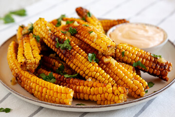 Homemade Spicy Corn Ribs with Mayo on a Plate, side view. Close-up.