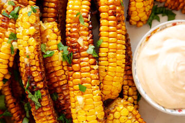 Homemade Spicy Corn Ribs with Mayo on a Plate, top view. Close-up.