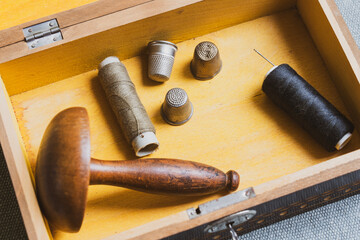 Collection of vintage sewing tools in an old sewing box